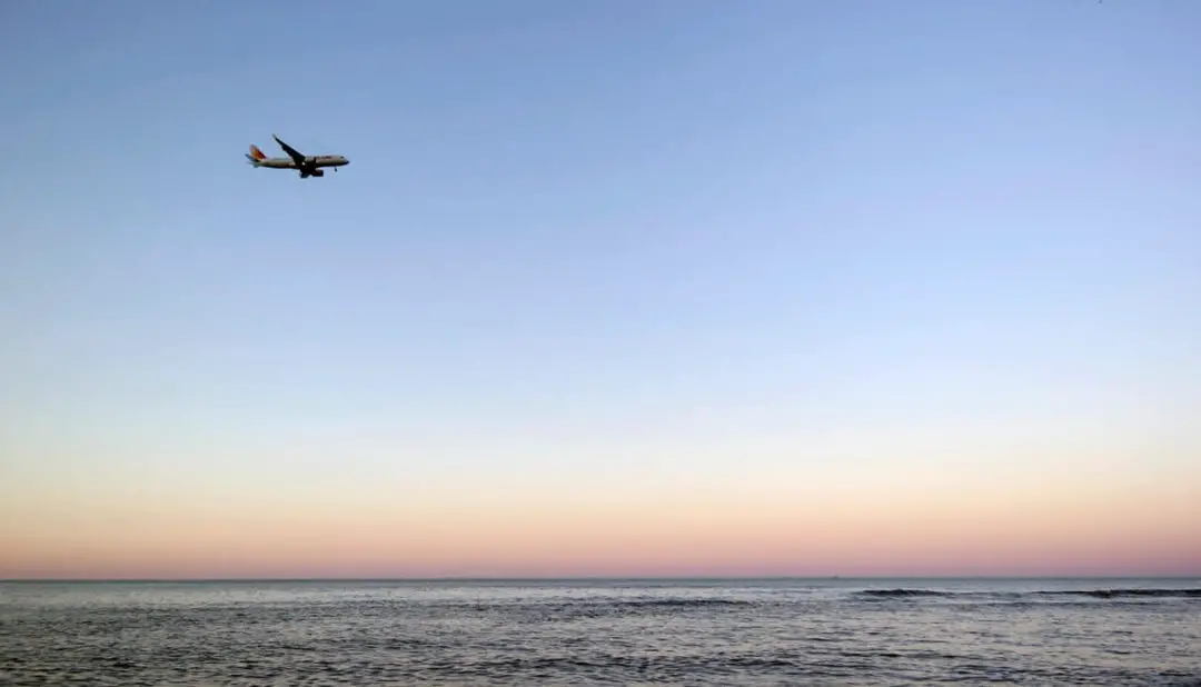 Fast Track Airport Services: Plane flying into the sunset