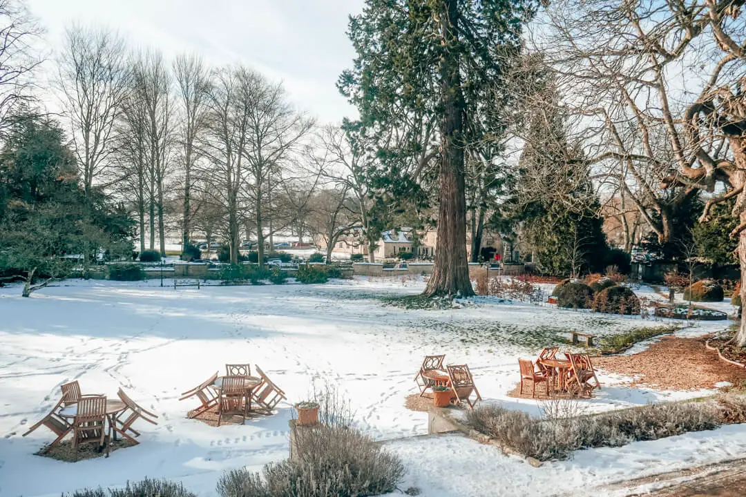 Gardens covered in snow at Slaughters Manor House Hotel, a luxury boutique hotel in The Cotswolds